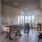 Apartments for Rent in Charlotte, NC - Amaze at Noda - Game Room with Foosball Table, Lounge Chairs, High-Top Tables with Bar-Style Chairs, Pendant Lights, and Large Windows.