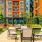 a patio with chairs and tables outside of a building