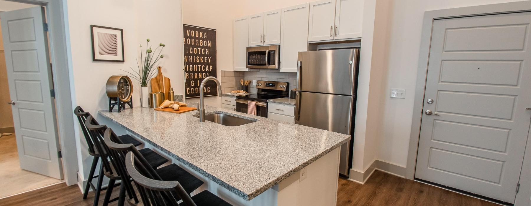 a kitchen with a marble island