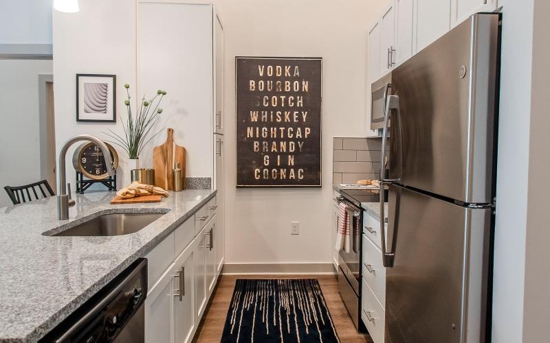 a kitchen with a refrigerator and a sink